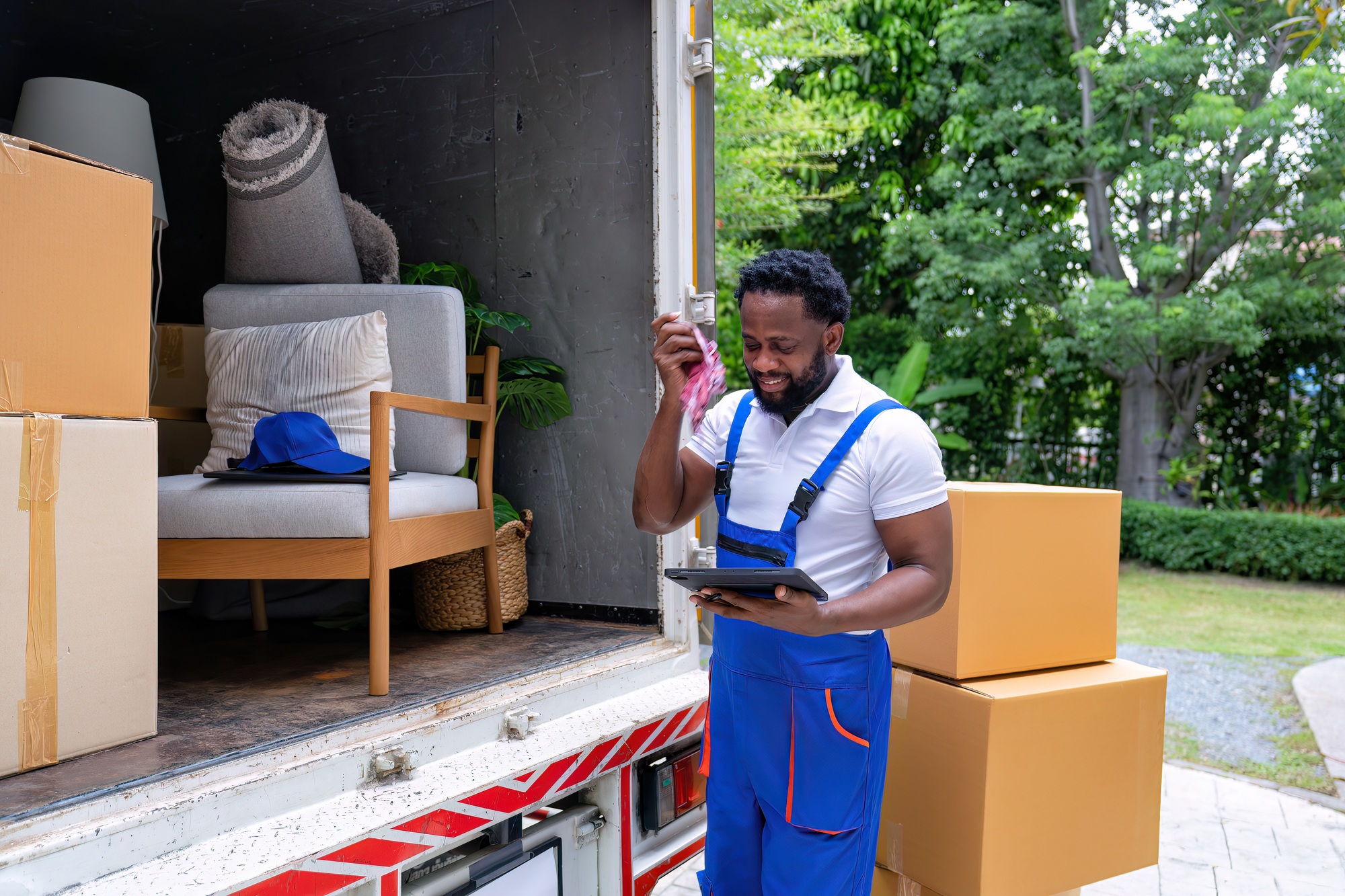 Delivery house move cargo truck service man hold flannel remove sweat from face on summer day